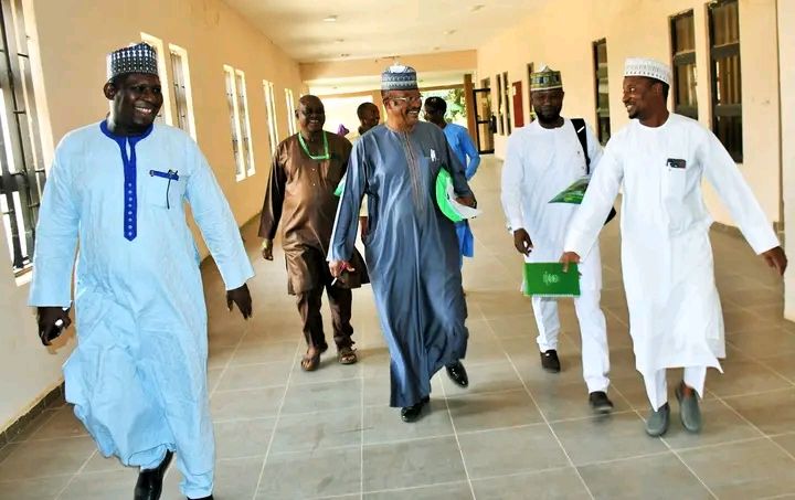 Faculty staff walking through the building corridor